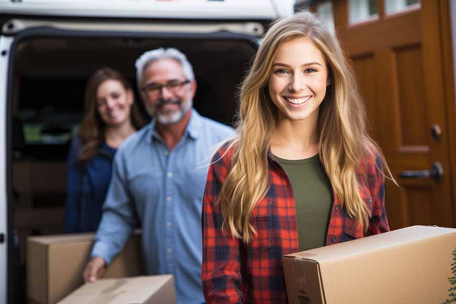 A young woman smiling as she heads off to college thanks to the Prime Savings Account her parents opened many years ago.